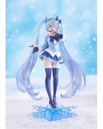 Snow Miku en tenue bleue hivernale sur son socle flocon translucide.